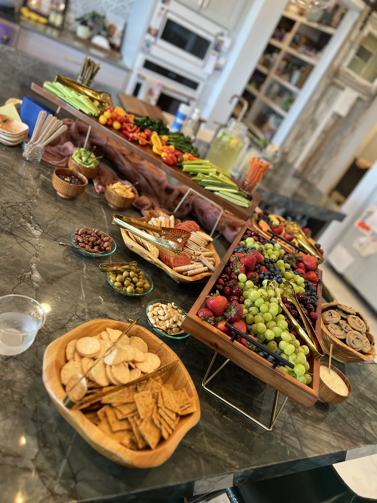 A grazing table spread of fruit, cheese, and crackers
